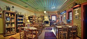 a restaurant with tables and chairs in a room at Frontzu Politia in Ioannina