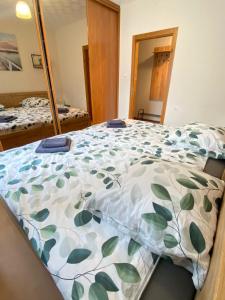 a bedroom with a bed with a blanket on it at Apartament na Placu Swietego Sebastiana in Opole