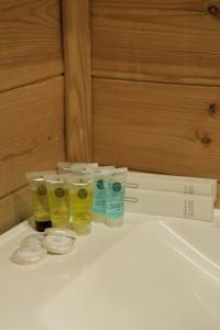 a group of four containers of liquids sitting on a counter at Pana Nomad Kolsay in Kurmenty