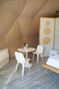 a room with a table and chairs in a tent at Pana Nomad Kolsay in Kurmenty +126 photos