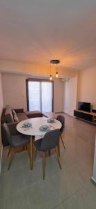 a living room with a table and a couch at Your Home in Xanthi