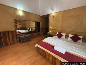 a bedroom with a large bed and a large mirror at Odyssey Stays Darap in Pelling +21 photos