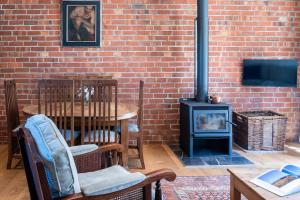 a brick wall with a wood stove in a room at Historic Castle Coach House in Earnscleugh