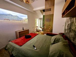 a bedroom with a bed with a view of a mountain at L'Oiseau du Paradis - Cottage & Spa in Lourdes