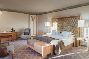 a hotel room with a bed and a desk at Carlton Hotel St Moritz - The Leading Hotels of the World in St. Moritz +99 photos