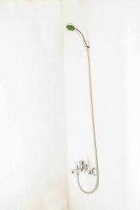 a shower with a shower head in a bathroom at Kiên Cường 2 Hotel in Da Nang