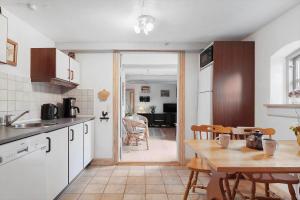a kitchen with a table and a dining room at SJ213-Fredericia-Blahoj-26 in Fredericia