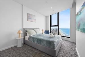 a bedroom with a bed with a view of the ocean at 43 Level Ocean View Apartment - Pet Friendly in Gold Coast +27 photos