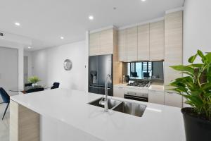 a kitchen with a white counter top and a sink at 43 Level Ocean View Apartment - Pet Friendly in Gold Coast