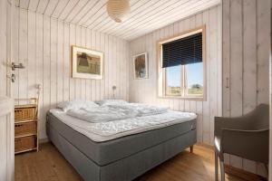 a bedroom with a bed and a window at LN2031-Hjorring-Gabet-3 in Lønstrup