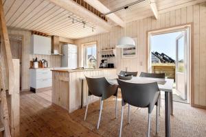 a kitchen with a table and chairs in a room at LN2031-Hjorring-Gabet-3 in Lønstrup +15 photos