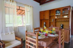 a kitchen with a wooden table with drinks on it at White cabin - Casa de Campo em Gonçalves - MG in Gonçalves +26 photos