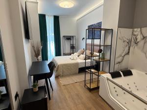 a bedroom with a bed and a tub in a room at Ventura Luxury in Alicante