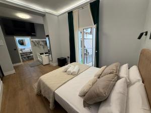 a bedroom with a white bed and a large window at Ventura Luxury in Alicante