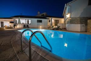 a swimming pool in a villa at night at Casa Oliveira in Fátima