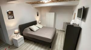 a small bedroom with a bed and a tv at BENSOgnare in Santena