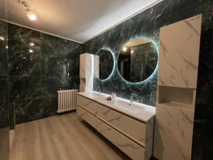 a bathroom with a sink and a mirror at BENSOgnare in Santena +7 photos