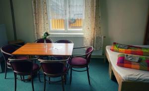 a room with a table and chairs and a bed at Penzion Villa in Janske Lazne +51 photos