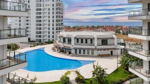 an aerial view of a building with a swimming pool at Helena Sea Breeze Apartments - Resort Living with Pools & Full Facilities in Kalecik