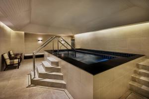 a swimming pool with a hot tub in a building at JW Marriott Hotel Bangkok in Bangkok +119 photos