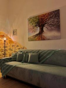 a couch in a room with a painting on the wall at Porta Mesta in Chios