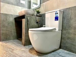 a white toilet in a bathroom with a sink at Villa Green View in Hikkaduwa +24 photos