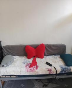 a couch with two red bows on it at Charmant studio in Paris