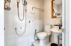 a bathroom with a toilet and a shower and a sink at Cat House BKK in Bangkok +40 photos