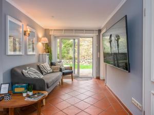 una sala de estar con un sofá y una mesa en Beach Bungalow Sylt 2, en Dikjendeel