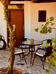 a patio with a table and chairs in front of a door at Porta Mesta in Chios