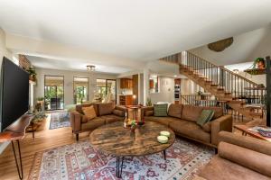 a living room with a couch and a table at Spacious Comfort in Scenic Monument in Monument
