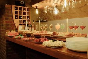 a buffet line with plates and glasses of wine at Enjoy Inn in Plzeň +87 photos