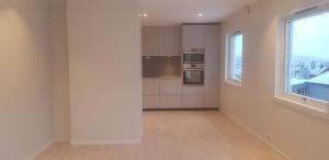 an empty room with a kitchen with a window at Tromsø, Skarvegen 18, two bedrooms in Tromsø