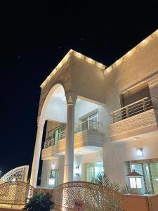 a large building with an arch in front of it at Airport Villa Amman in Amman