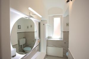 a bathroom with a toilet and a sink and a mirror at Airport Palace Cinisi in Cinisi +47 photos