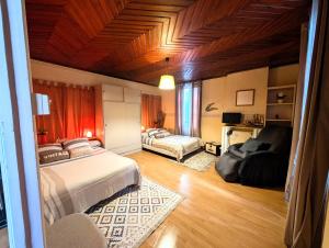 a bedroom with two beds and a living room at L'échappée Huroise, piscine et spa privatifs in Hure +18 photos