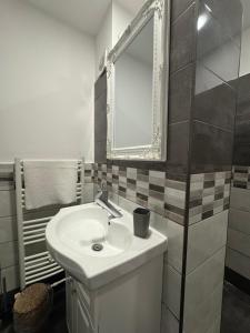 a bathroom with a sink and a mirror at La Livada in Otopeni