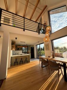 a living room with a dining table and a loft at Stodoła Bieszczady in Nowy Zagórz