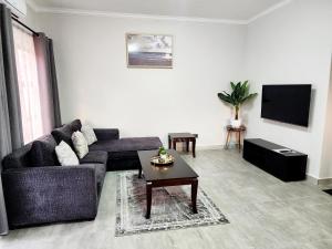 a living room with a couch and a coffee table at Bole Suites in Lilongwe