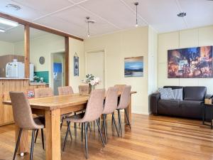 a dining room with a wooden table and chairs at Nautique Beach House - Rustic and Charming, Walk 2 Beach & Shops in Rosebud