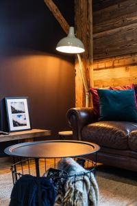 a living room with a couch and a table at Chalet Saint De l'Elephant in Saint-Jean-dʼAulps