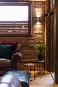 a living room with a couch and a window at Chalet Saint De l'Elephant in Saint-Jean-dʼAulps