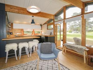 a kitchen with a counter and some chairs in a room at Blue Pine Lodge in Embo