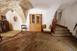 a living room with a stone ceiling and a staircase at Appartement villageois ou maison entière in Aniane