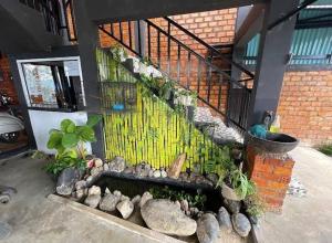 a stone bench in front of a house with a staircase at Homestay Danau sipin jambi in Jambi
