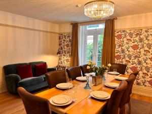 a dining room with a table and chairs and a couch at Lyme Regis Luxury Escape in Lyme Regis