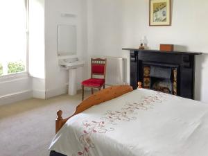Saint IshmaelsにあるThe Bungalowのベッドルーム1室(ベッド1台、暖炉付)
