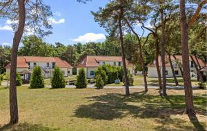a row of houses in a park with trees at Amazing Apartment In Altenkirchen With Wifi in Altenkirchen