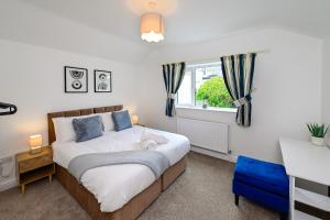 a bedroom with a large bed and a window at Cosy Mumbles Escape Fun & Relax in The Mumbles