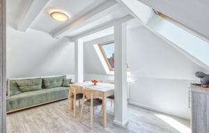a living room with a table and a couch at Stunning Apartment In Altenkirchen in Altenkirchen